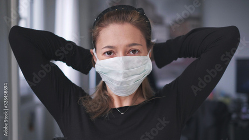 horizontal background of woman wearing surgical mask for corona virus isolation photo