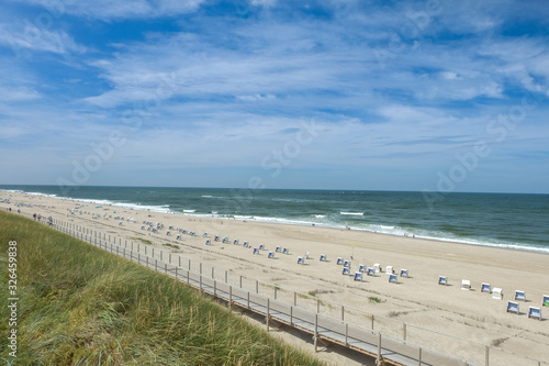 Panorama  Sommerliche Strandidylle auf der beliebten Nordseeinsel Sylt zwischen Westerland und Wenningstedt mit Standk  rben und Besuchern -  Personen im Hintergrund auch vergr    ert nicht erkennbar