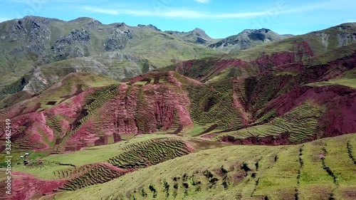 Aerial, drone shot panning over Inca terraces, revealing a small town, near Palcoyo, on a sunny day, in Cusco, Peru, South America photo