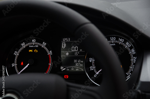 Car dashboard with speedometer, tachometer