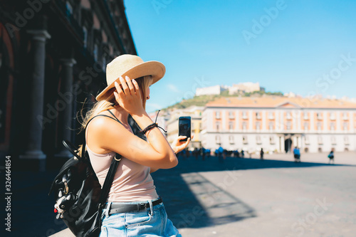 Rome Europe Italia travel summer tourism holiday vacation background - young girl with hat mobile phone and using action camera backpack in hand standing on the hill looking on the cathedral old city