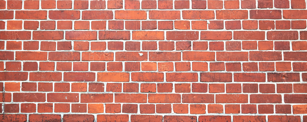 Fototapeta premium Red color brick wall for brickwork background design. Panorama format.