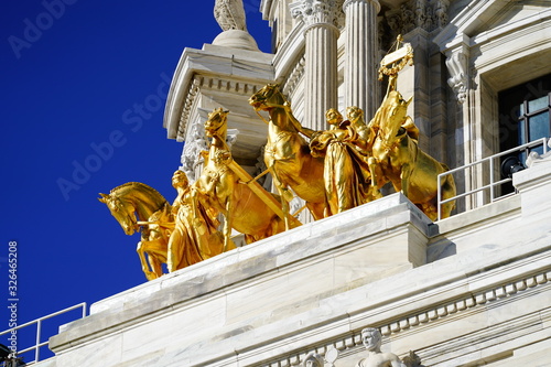 The Quadriga progress of the state. Golden statues to top of Minnesota state Capitol building.