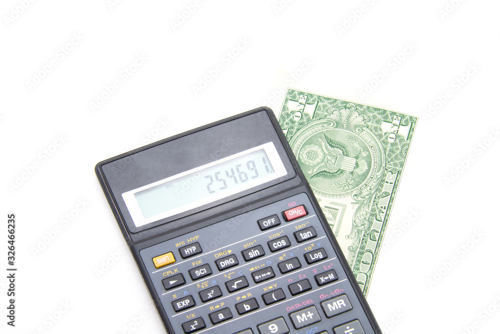 A black engineering calculator (not completely, but part) with gray and black buttons and a banknote of one American dollar under it. White isolated background. Accounting for finance and budget. A black engineering calculator (not completely, but part) with gray and black buttons and a banknote of one American dollar under it. White isolated background. Accounting for finance and budget.