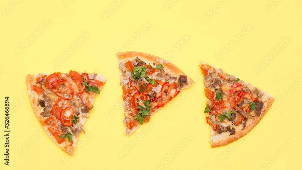 Fototapeta Three slices of pizza on a yellow background