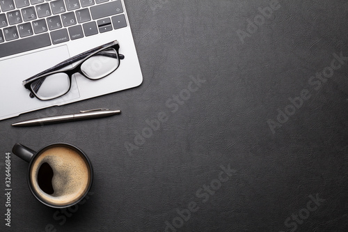 Office desk table with laptop, supplies and coffee