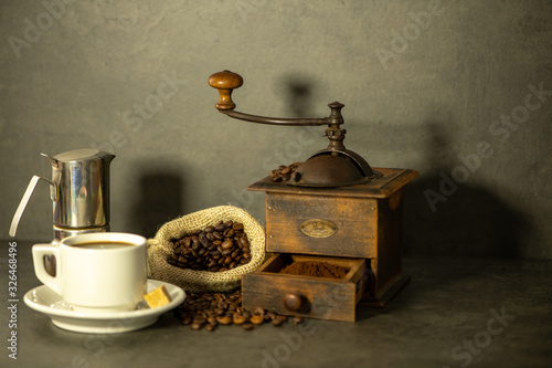 coffee grinder and beans on wooden background