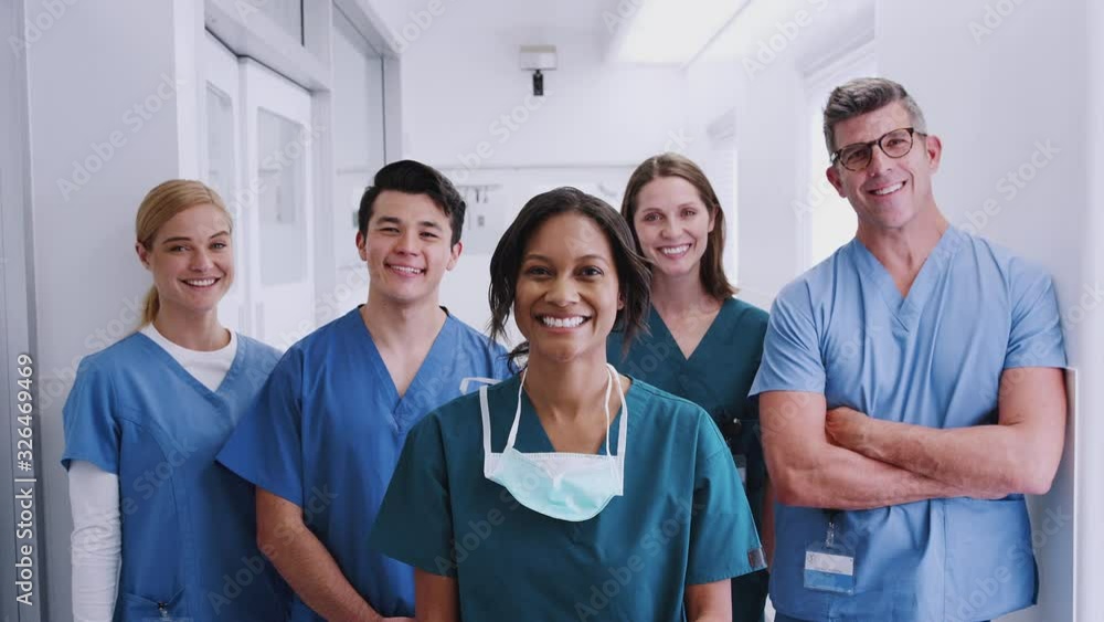 Portrait Of Smiling Multi-Cultural Medical Team Standing In Hospital Corridor Portrait Of Smiling Multi-Cultural Medical Team Standing In Hospital Corridor