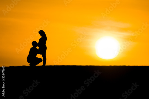 Couple silhouette giving love each other