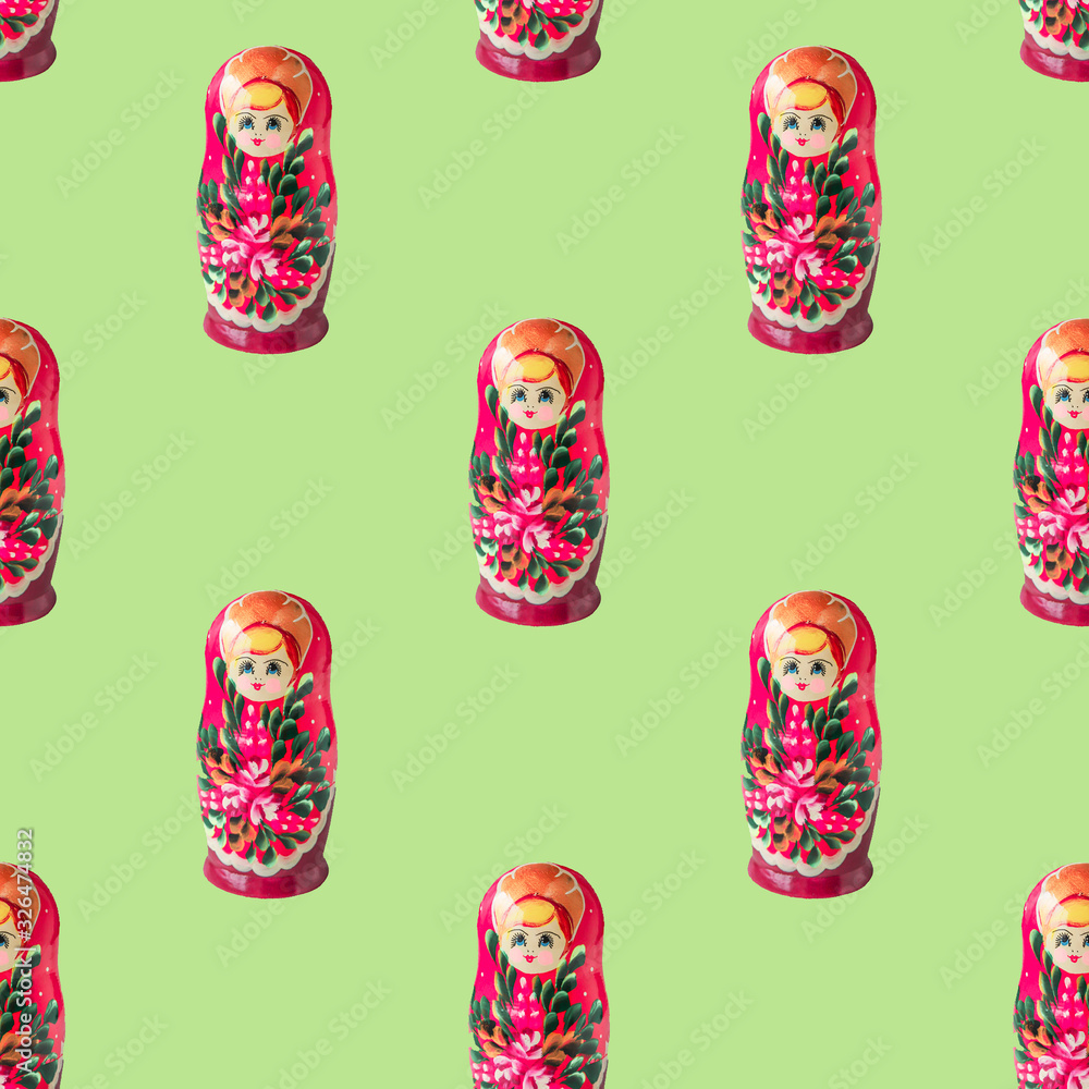 Russian doll matryoshka or babushka seamless pattern on light green background. Moscow traditional toy texture for design or print