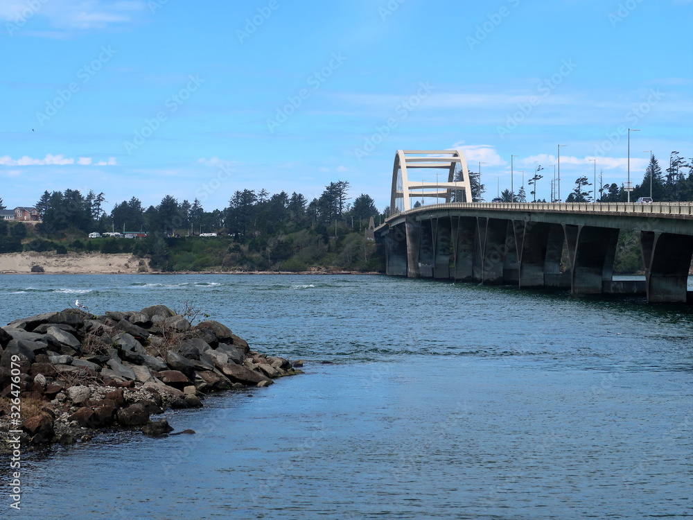 The Alsea Bay Bridge along coastal highway 101 connects Waldport and Bayshore on the Central Oregon Coast on a sunny spring day.