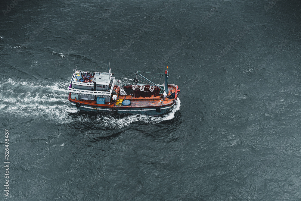 Obraz premium Lonely fisherman deep in the sea near coast of Vietnam