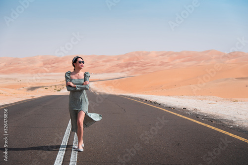 Woman walking on the scenic dessert road