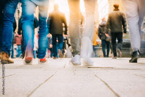 Crowd of people walking in motion in downtown rush hour