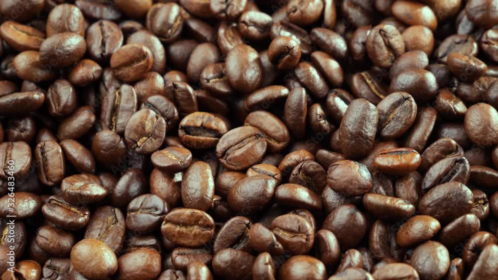 The coffee beans are roasted and mixed with a spoon. The coffee beans are roasted and mixed with a spoon.