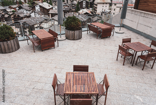 Swiss Alps. outdoor terrace with wooden benches and tables. outdoor recreation. Cafe or hotel terrace photo