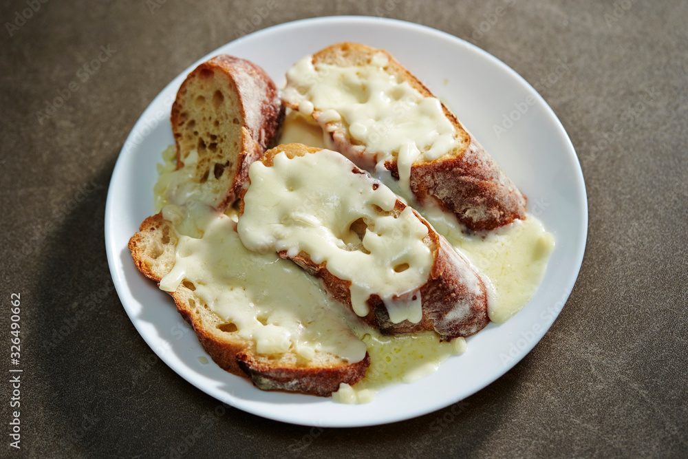 Melting cheese on baguette slice Melting cheese on baguette slice
