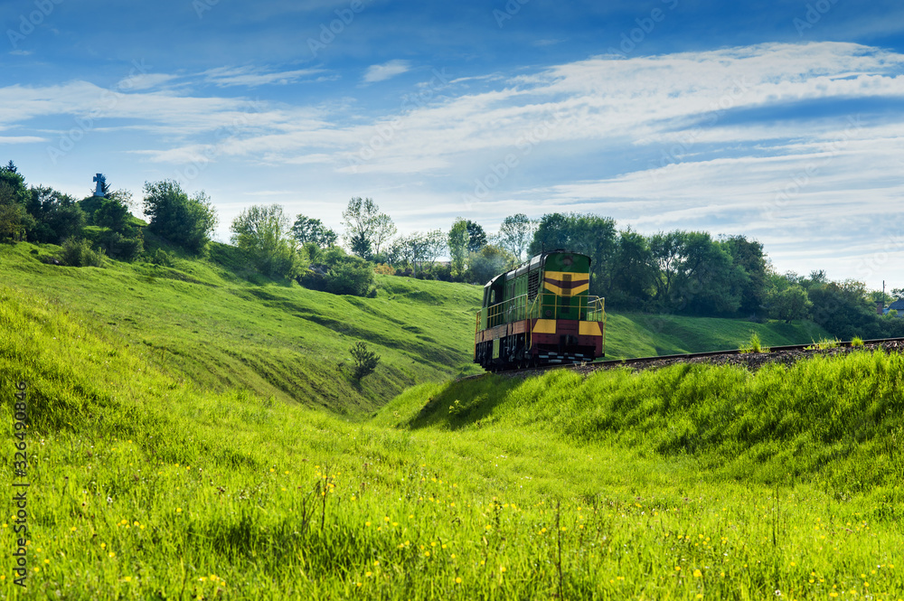 Diesel locomotive on a green grassy slope, beautiful landscape Ternopil region, Ukraine Diesel locomotive on a green grassy slope, beautiful landscape Ternopil region, Ukraine