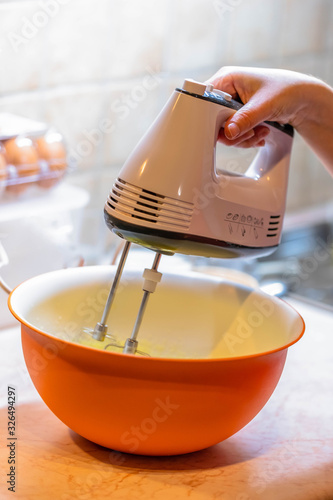 a knob of butter and sugar icing mix in a metal mixing bowl ready to be prepared into a cake recipe. Sweet deserts being prepared from scratch. scoop of icin photo