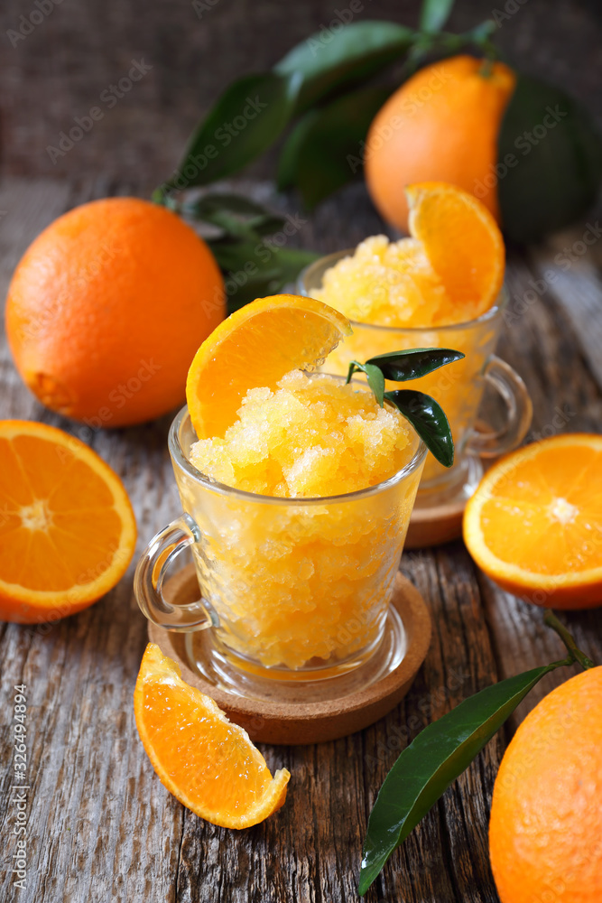 Orange granita, frozen summer dessert and freshe orange fruits Orange granita, frozen summer dessert and freshe orange fruits