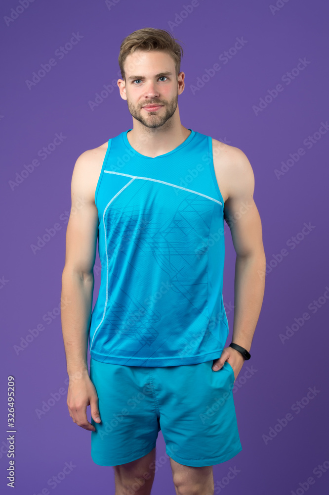 Sport clothes. Outfit for better results. Sportsman training with pedometer gadget. Sport gadget concept. Man athlete sport equipment violet background. Athlete with bristle wear fitness tracker Sport clothes. Outfit for better results. Sportsman training with pedometer gadget. Sport gadget concept. Man athlete sport equipment violet background. Athlete with bristle wear fitness tracker