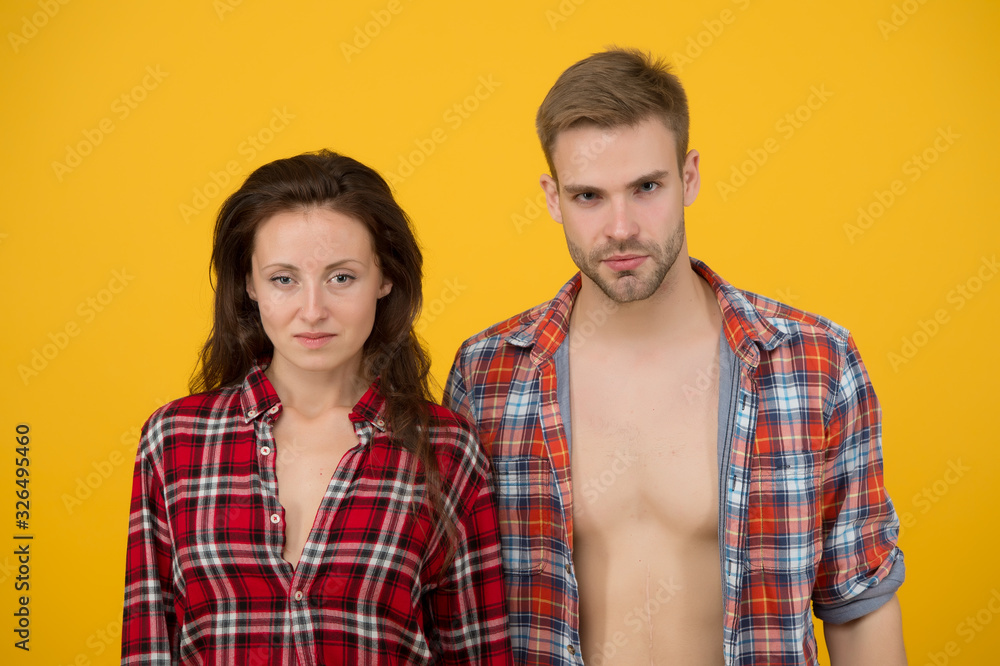 couple wear checkered shirts. sexy couple in love. concept of relationship. youth casual fashion style. he feels confident. female looking seriously. Happy valentines day. Good looking duo in denim couple wear checkered shirts. sexy couple in love. concept of relationship. youth casual fashion style. he feels confident. female looking seriously. Happy valentines day. Good looking duo in denim
