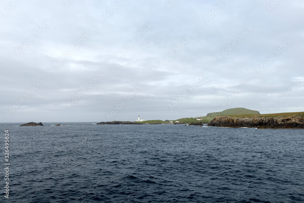 Green islands at sea in Scotland, United Kingdom. Green islands at sea in Scotland, United Kingdom.