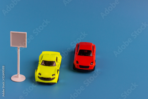 Small toy cars. Miniature children’s models of cars on a blue background.