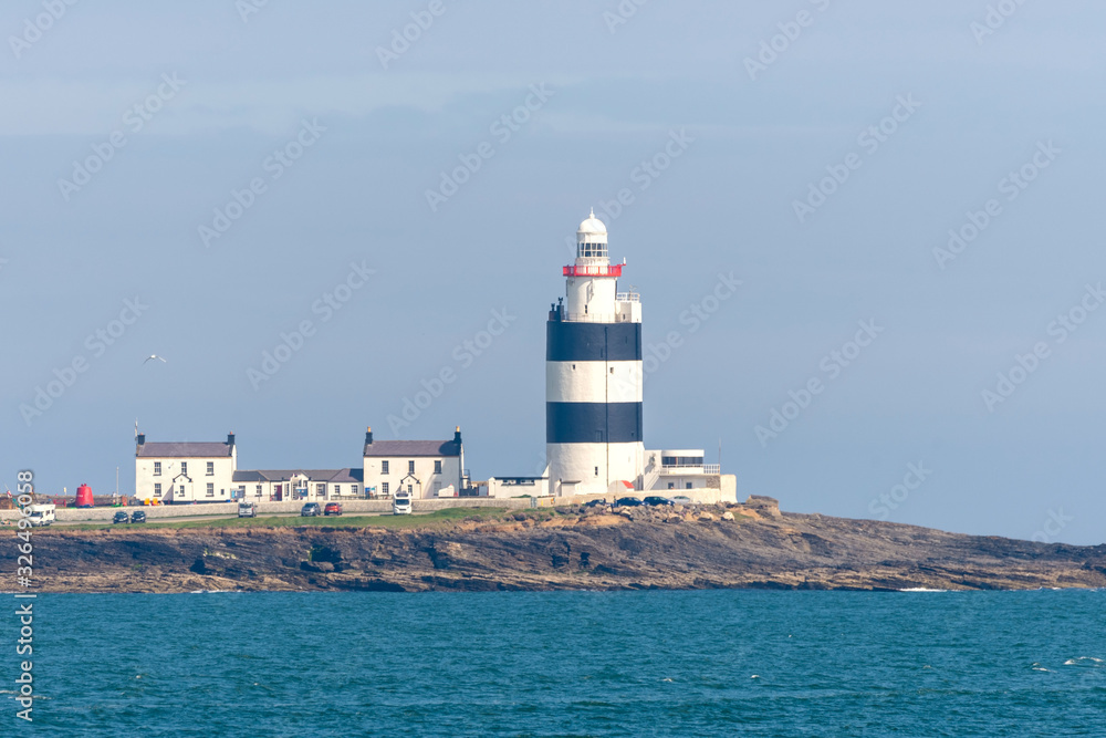 Lighthouse on small island at sea in Scotland, United Kingdom.