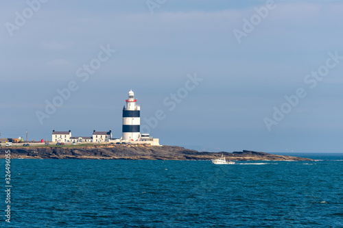 Lighthouse on small island at sea in Scotland, United Kingdom.