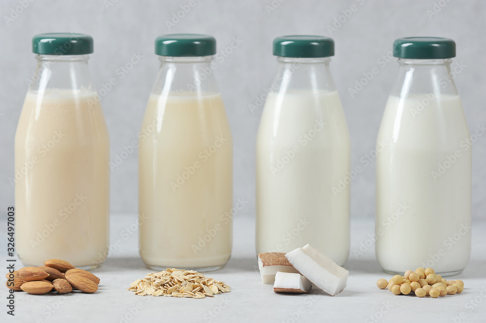 Concept alternative to cow's milk. Bottles with coconut, oat, soy and
