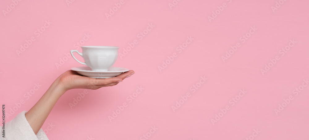 Coffe please. Female hand holding a cup of coffee isolated on pink background. Time to charge battery. - obrazy, fototapety, plakaty 