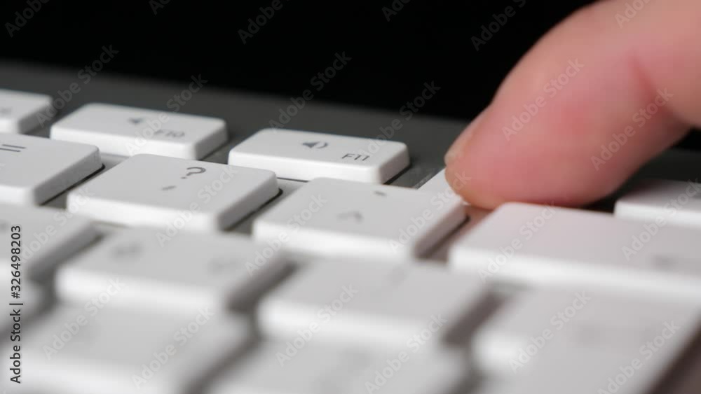 Finger pressing repeatedly the F12 function key on keyboard. Close-up Finger pressing repeatedly the F12 function key on keyboard. Close-up