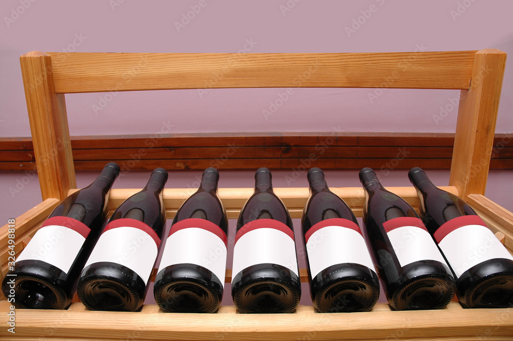 Naklejka premium Leaning red wine bottles on the table at restaurant.