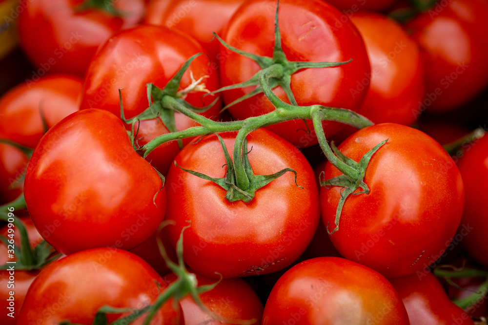A full frame photograph of tomatoes for sale on a market stall A full frame photograph of tomatoes for sale on a market stall