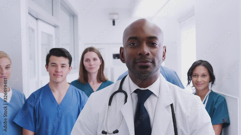 Portrait Of Multi-Cultural Medical Team Standing In Hospital Corridor Portrait Of Multi-Cultural Medical Team Standing In Hospital Corridor