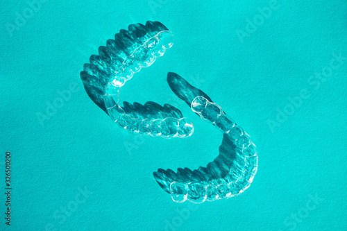 Invisible aligners teeth brackets on blue background