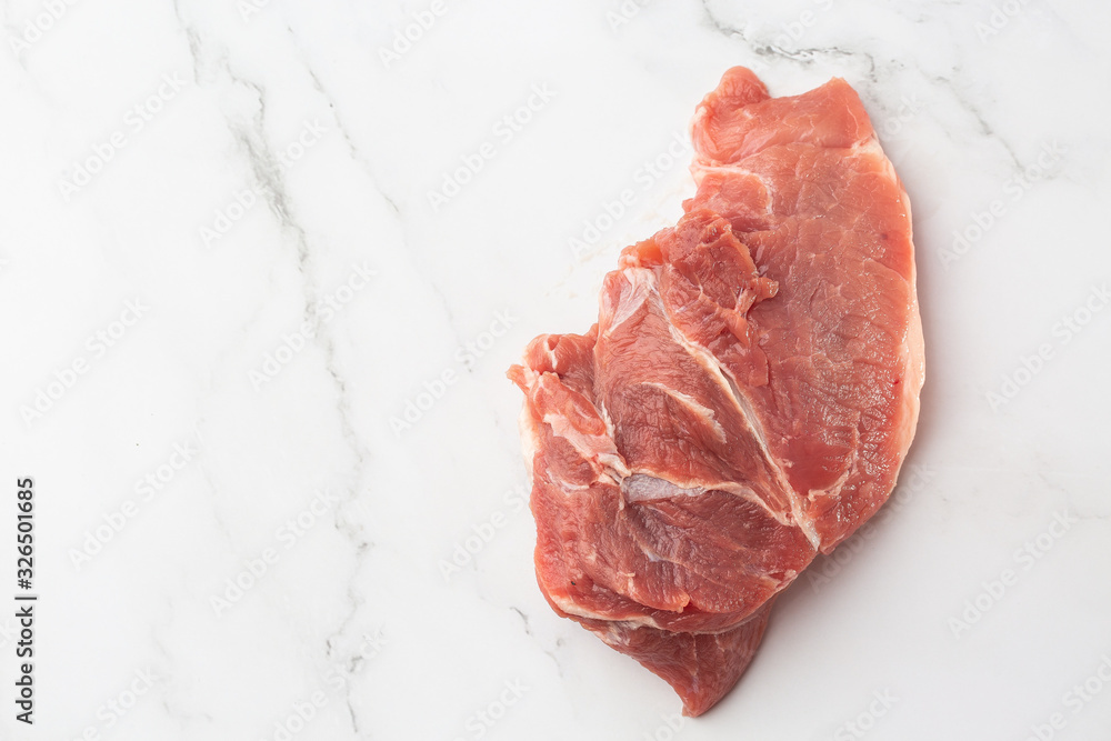 Meat, pork, slices pork loin on a white background. Raw pork meat. Advertising for meat shop and farm. Various kinds of meat and ready to cook concept. Top view. Space for text