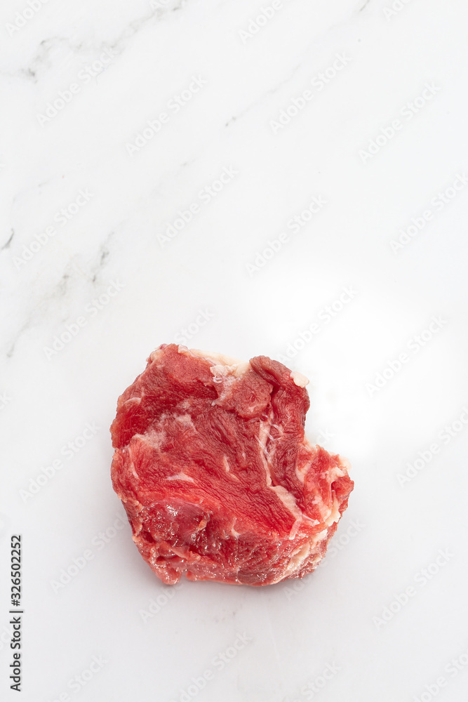 Meat, beef, slices beef loin on a white background. Raw meat. Advertising for meat shop and farm. Various kinds of meat and ready to cook concept. Top view. Space for text