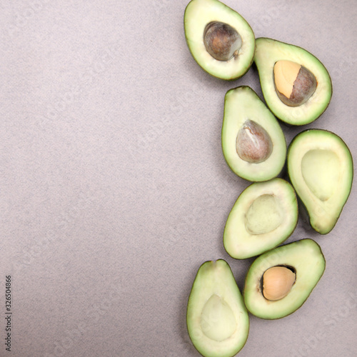 Avocado-ripe and bright, cut in half - on a beige background close-up copy space. Space for text
