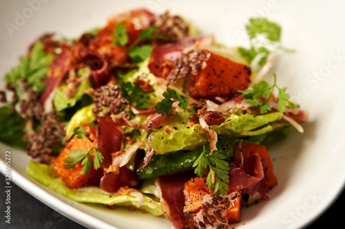 Smoked duck meat with baked pumpkin and lettuce leaves