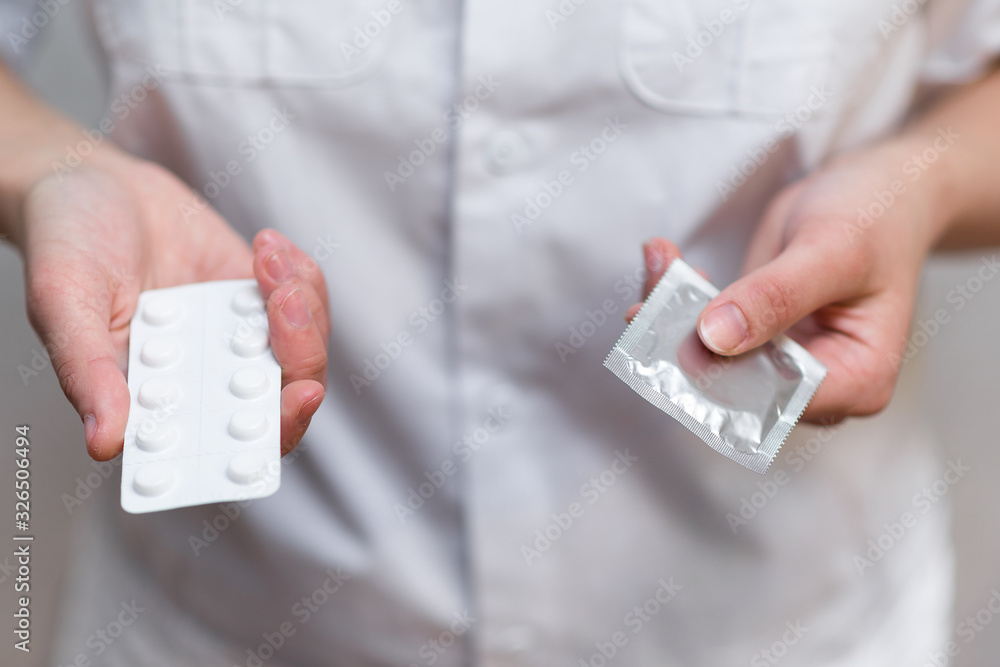A female doctor in a white coat gives a choice of contraceptives