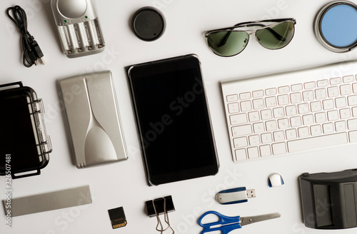 Flat assembly composition with photographic production equipment on plain white background, top view