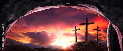Print op canvas View Of Three Wooden Crosses And Sunrise From Open Tomb - Death And Resurrection