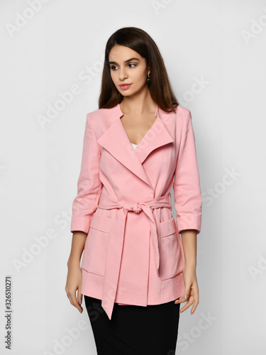 Young fashionable beautiful curly hair girl blogger trying on an expensive designer stylish light pink office suit jacket © Dmitry Lobanov