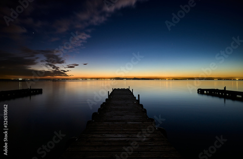 walkways on a lake at dusk