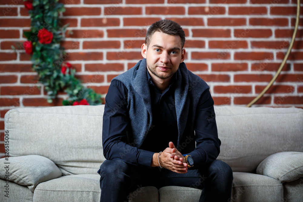 young guy businessman in a shirt on a sofa young guy businessman in a shirt on a sofa