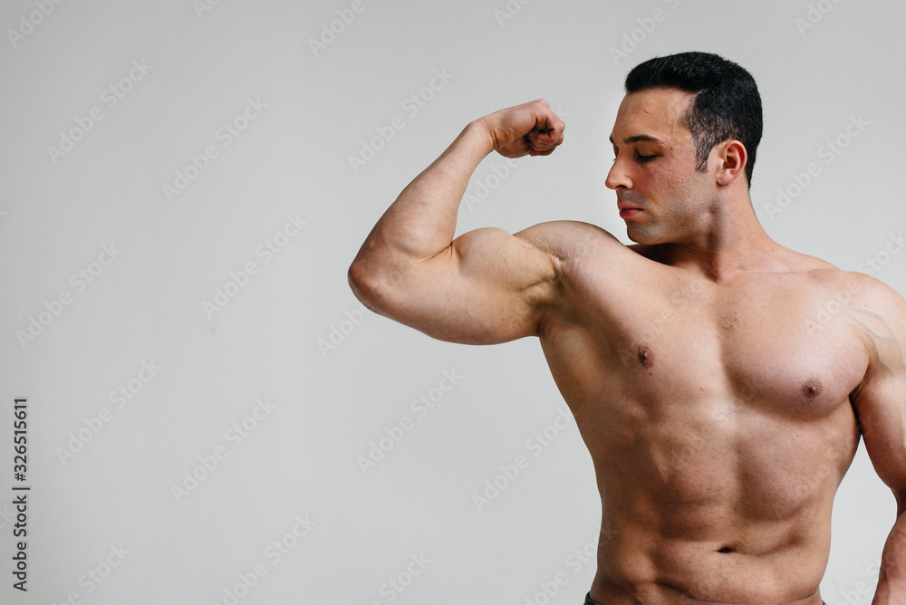 Sexy athlete posing on a white background Topless. Fitness Sexy athlete posing on a white background Topless. Fitness