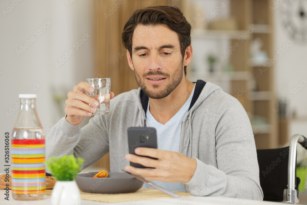 man holding credit card and laptop while having lunch man holding credit card and laptop while having lunch