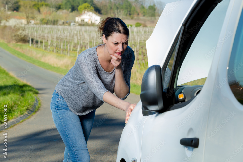 woman having trouble with her vehicle woman having trouble with her vehicle